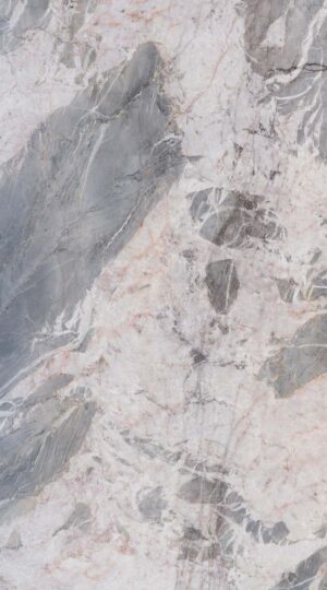 Monte Azul Polished Quartzite presents a refined and elegant composition, a testament to nature's subtle yet powerful artistry. Its polished surface enhances a sophisticated grey base, which transitions with graceful fluidity from deep, shadowy charcoal to soft, misty silver. Scattered across this serene landscape are distinct bodies of pure white, like clouds drifting across a twilight sky, providing moments of bright contrast and visual intrigue. This interplay of light and dark creates a balanced and harmonious aesthetic, offering a foundation of quiet luxury for any distinguished interior space. The true character of Monte Azul is revealed in its details. Along the periphery of the main color fields, intricate, thinner veins emerge in a complex and delicate network, adding a layer of remarkable intricacy to the stone's overall appearance. This fine veining provides a subtle counterpoint to the broad sweeps of grey and white, showcasing the material's geological story. Ideal for expansive countertops, graceful wall cladding, or sophisticated fireplace, Monte Azul Polished Quartzite delivers a timeless and elegant statement, backed by the enduring strength and quality inherent to natural quartzite.