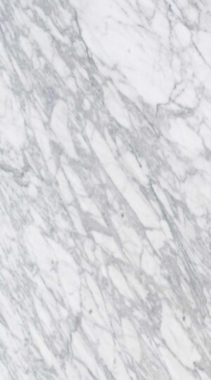 The color palette of Calacatta Apuano Marble is nothing short of breathtaking, showcasing a luminous white backdrop interwoven with bold, dramatic veins in shades of charcoal, soft gray, and occasionally golden hues. This striking interplay of tones creates an aura of timeless sophistication, evoking the allure of classic marble but with the enhanced durability of quartzite. Calacatta Apuano Marble is a masterpiece of natural beauty, originating from the renowned Apuan mountains in Italy—an area celebrated for its legacy of exquisite stone craftsmanship. This distinctive marble embodies the elegance and grandeur of its Italian heritage, making it a centerpiece of luxury in contemporary design.