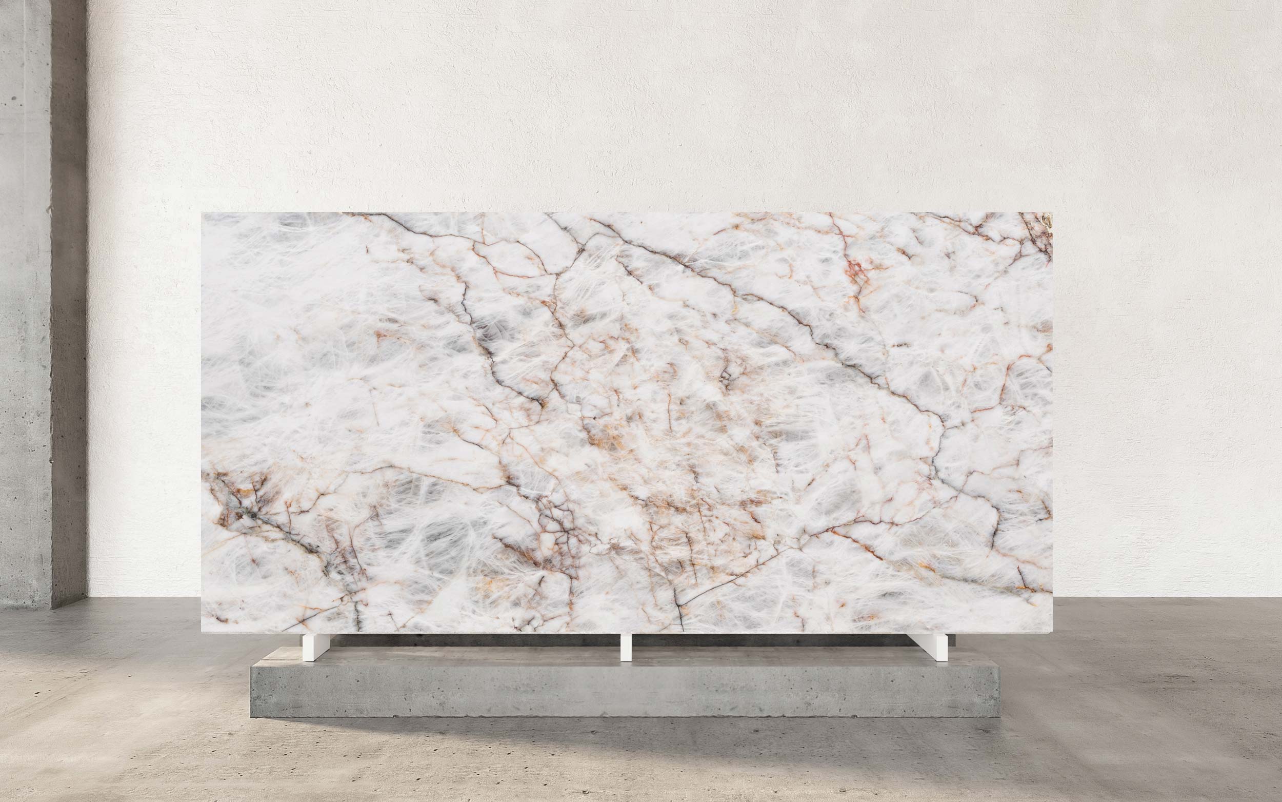 Cristallo Matterhorn Quartzite is a captivating natural stone that mirrors the rugged beauty and dramatic allure of the Matterhorn mountain in the Alps. Its luminous, translucent white base is gracefully intertwined with bold, dynamic veins, creating a striking visual reminiscent of the mountain’s steep peaks and cascading slopes. This intricate veining adds depth and character, reflecting both the majesty of nature and the artistry of design. The polished finish of Cristallo Matterhorn Quartzite amplifies its elegance, offering a radiant sheen that enhances the contrast and complexity of its veining. The smooth, mirror-like surface not only exudes luxury but also showcases the stone's natural brilliance, making it a centerpiece in any space. With its luminous quality, this quartzite elevates interiors, infusing them with light and sophistication.