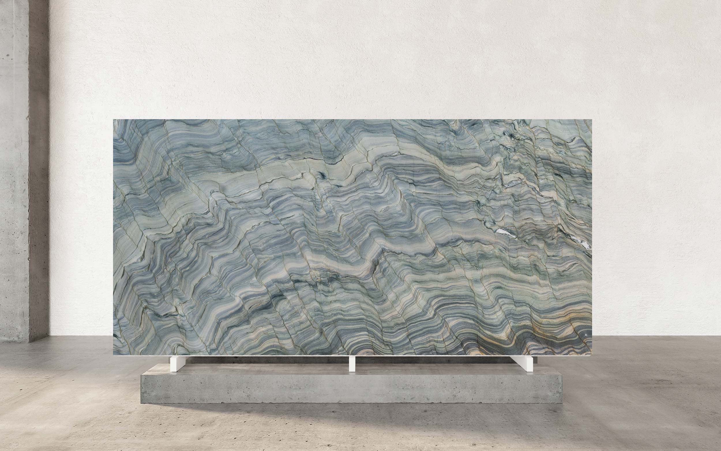 Fusion Polished Quartzite is an extraordinary spectacle of nature’s most daring artistry, capturing a dynamic and mesmerizing energy within each slab. The polished finish reveals a rich base of interwoven greens, unfolding from the warmth of olive and jade to cooler shades of seafoam and deep emerald. These verdant tones blend seamlessly, creating a visual rhythm that feels alive and continually evolving. The movement within the stone stands out as its most defining characteristic—a cascade of layered light and color that shifts and plays across the surface, evoking a sense of depth and vibrancy. Bands of light seem to hover just beneath the polished finish, offering an experience that is both sophisticated and powerfully captivating. This quartzite is not merely a surface but a transformative design element that commands attention and inspires awe. Its texture is a visual symphony of complex patterns and fluid motion, creating an almost hypnotic, psychedelic effect that seems to spin and evolve before your eyes. This powerful aesthetic makes Fusion Polished Quartzite an unparalleled choice for statement applications, such as a monolithic kitchen island, a dramatic feature wall, or a breathtaking countertop that serves as the centerpiece of a luxury space. For the discerning client seeking to infuse their environment with unparalleled energy and a piece of geological wonder, Fusion Polished Quartzite offers an unforgettable statement of bold, artistic expression and enduring quality.