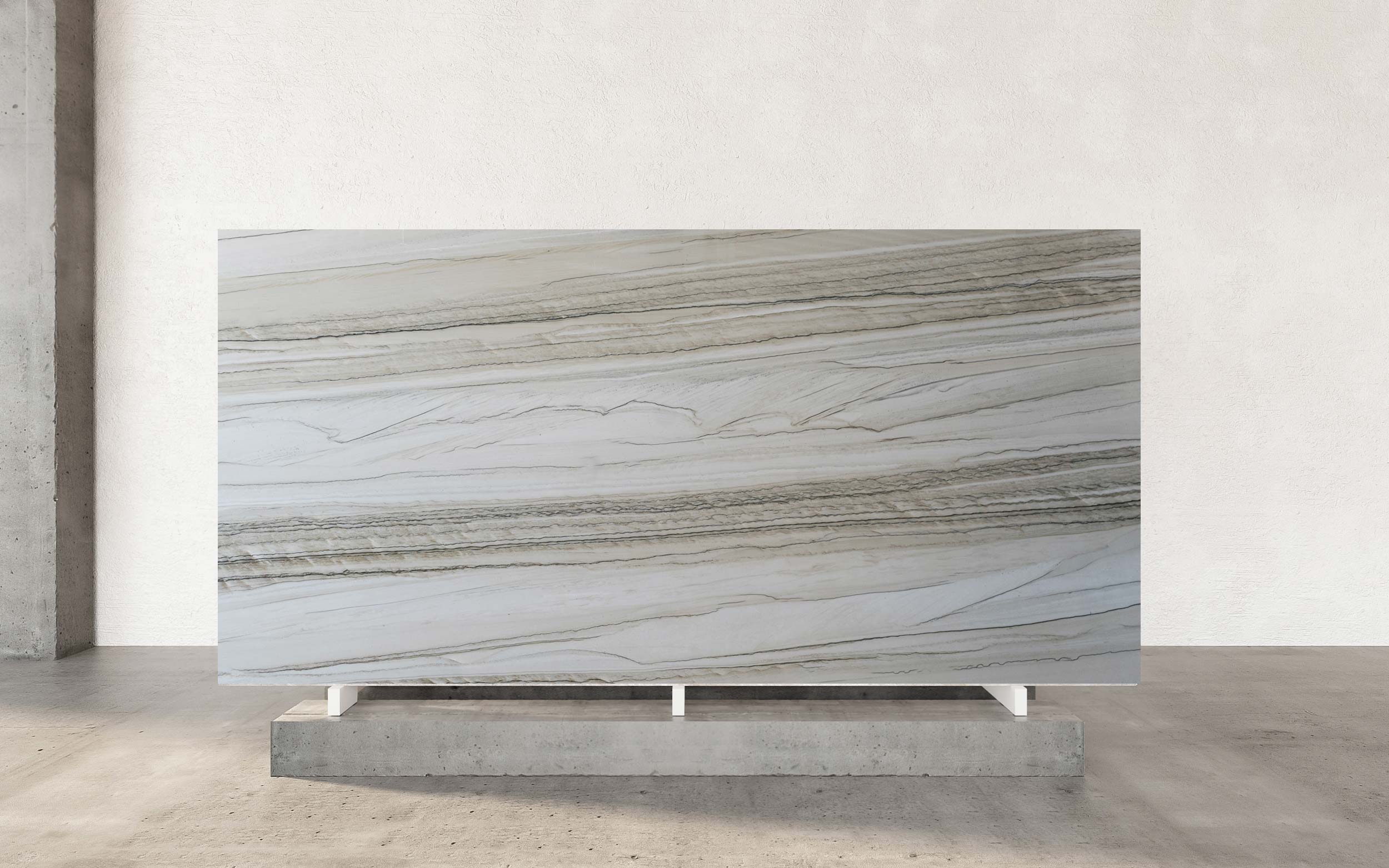 Chantilly Quartzite is a striking and elegant natural stone celebrated for its sophisticated color and intricate visual texture. The primary color is a serene and luminous white, serving as a pristine canvas. This soft white backdrop is beautifully contrasted by a delicate yet distinctive network of linear veining in shades of dark gray and deep navy blue. The veins are a defining characteristic, creating a rhythmic, almost lace-like pattern across the surface that adds a sense of movement and dynamic artistry.